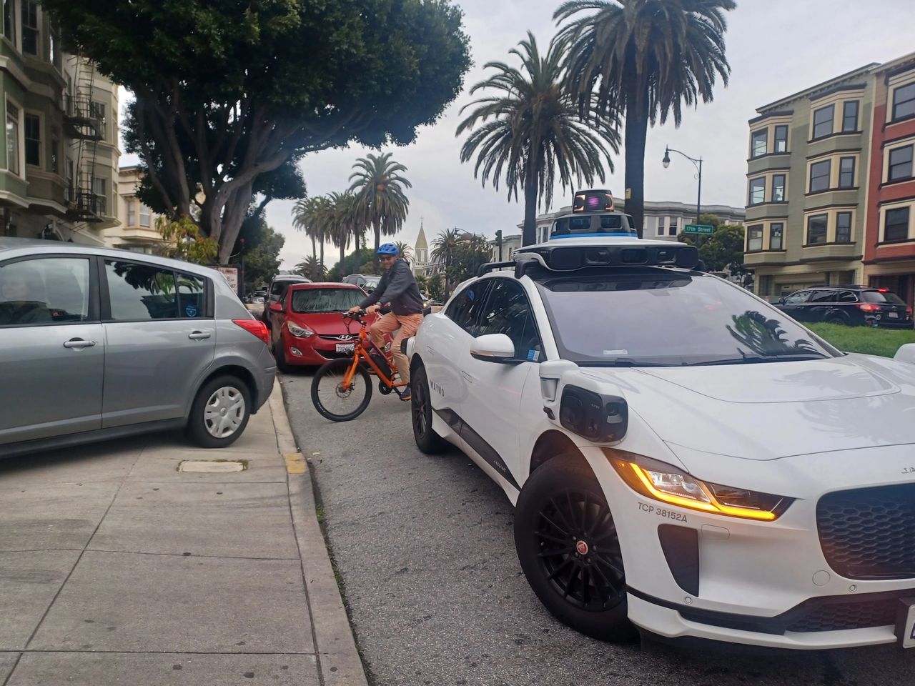 A Waymo blocks the entrance to Mission High School on February 16, 2024. This will get worse as the industry floods city streets with more vehicles -- unless local officials are empowered to restrict their numbers and/or places of operation.