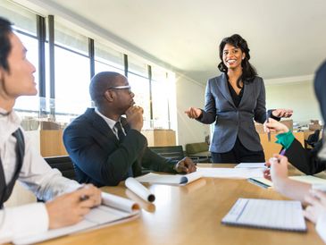 A business meeting with a female presenter