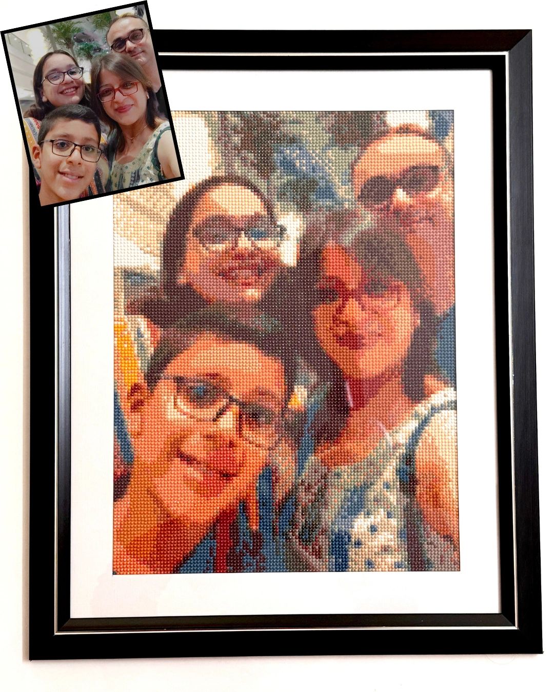Framed diamond painting of a smiling family selfie.