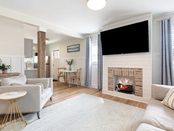 Cozy living room with fireplace and large TV.