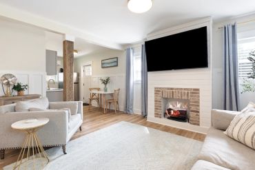 Bright living room with fireplace and TV.