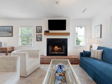 Bright living room with fireplace and blue couch.
