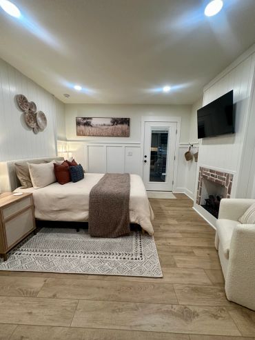 Cozy bedroom with modern decor and warm lighting.
