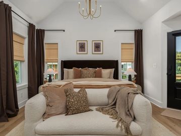 Cozy modern bedroom with neutral tones and soft lighting.