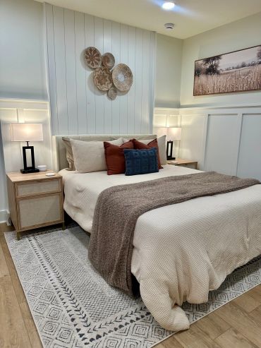 Cozy bedroom with neutral tones and decorative wall art.
