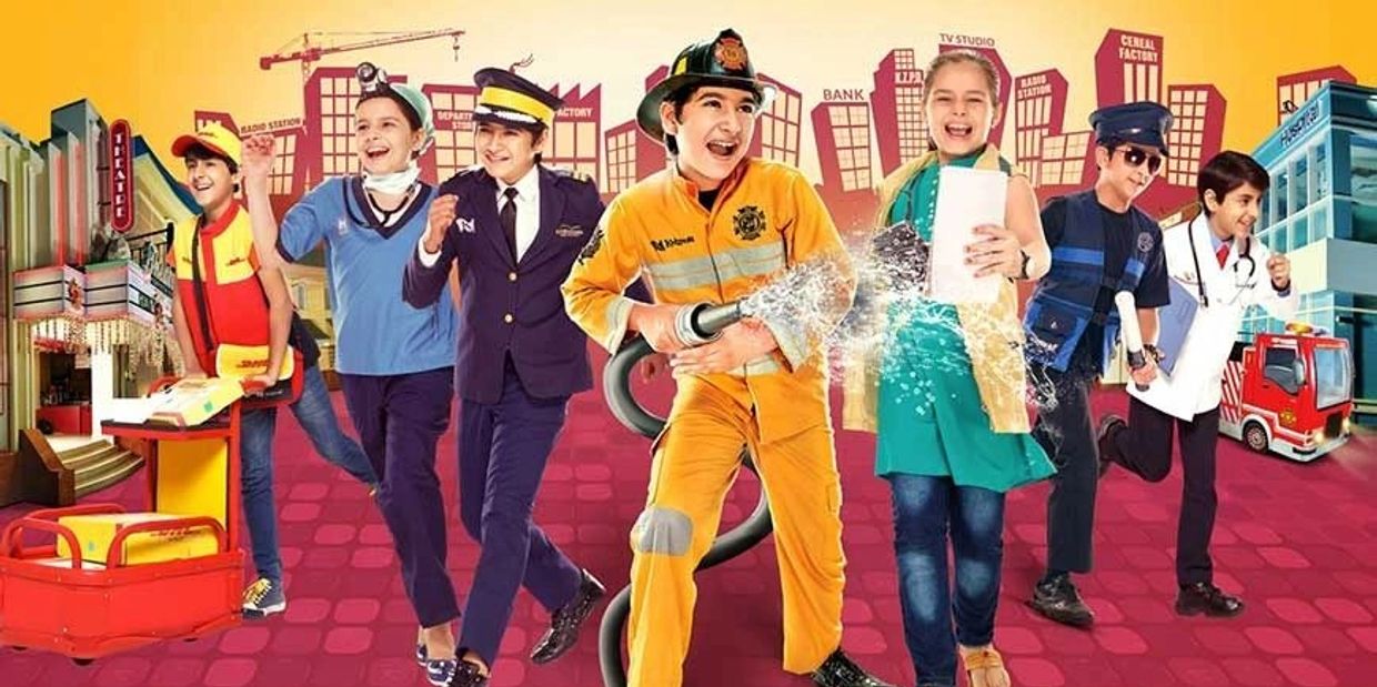 Children dressed as various professionals in a vibrant city backdrop.