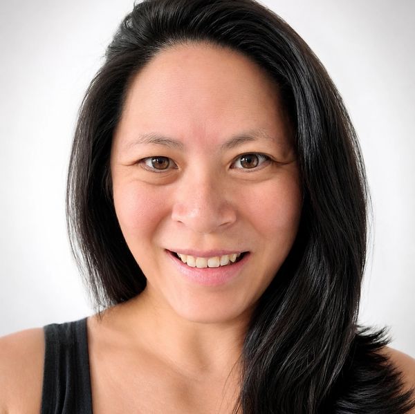 Smiling woman with long black hair.