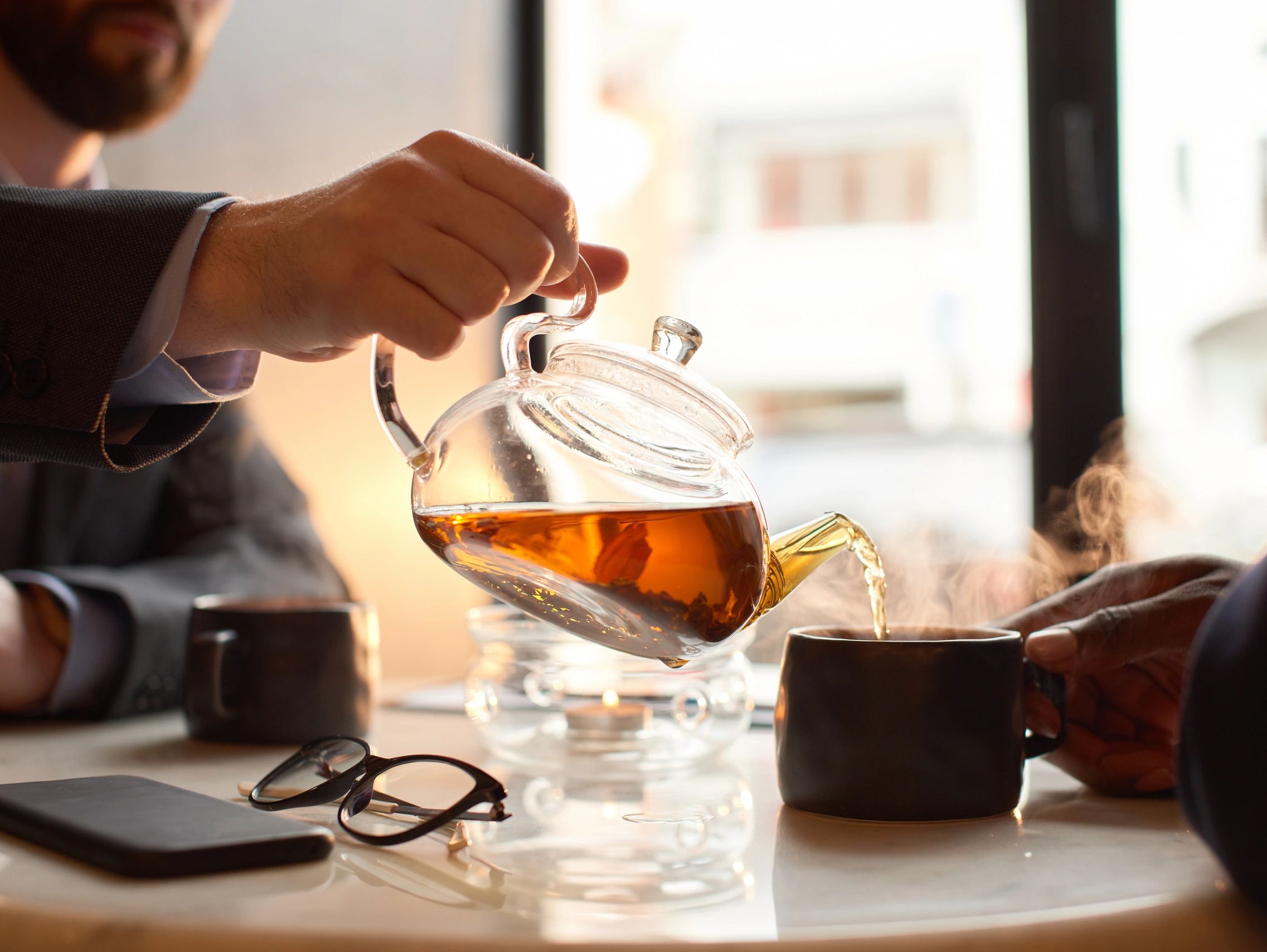 two gentlemen haveing a chat over tea