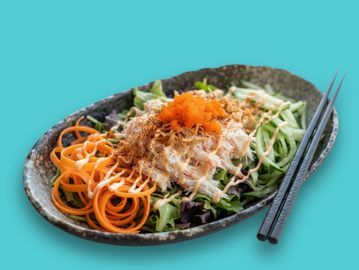 Fresh Asian salad with vegetables and chopsticks.