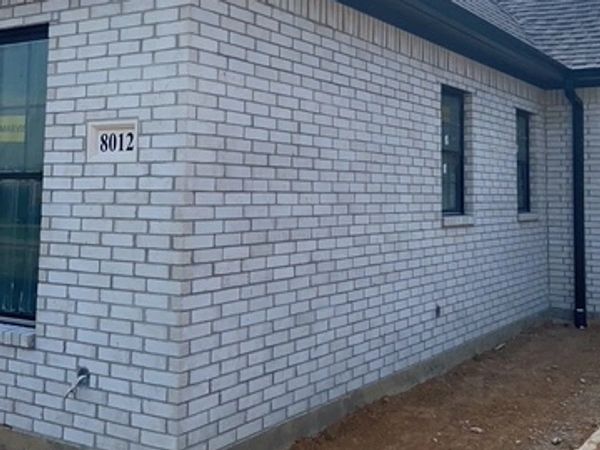 Brick house exterior with house number 8012.