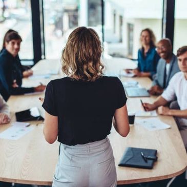 Woman leading a business meeting in a modern office.