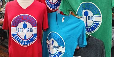 Colorful T-shirts featuring the historic Downtown Glendale, AZ logo from 1910.