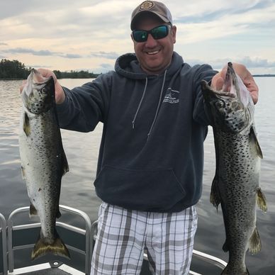 Maine Guide Outfitter trolling experience on a Maine Lake produces a couple fat landlocked salmon.