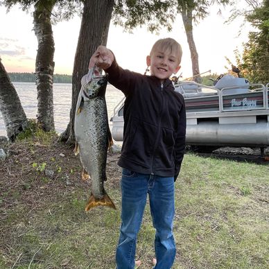 Young angler enjoys the thrill of landing a trophy fish with Maine Guide Outfitter on East Grand Lak