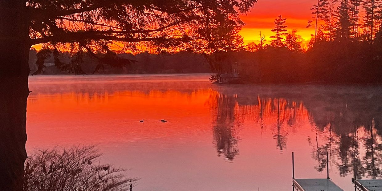 Sunset over China Lake, Maine - serene view for Maine guided fishing and hunting adventures with Mai