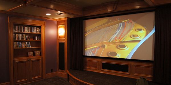 Custom home theater with stage, motorized drapes, bookcase with hidden room, custom carpentry louisv