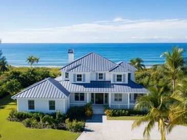 Beach house with blue roof and palm trees.