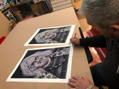 Artist signing prints