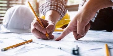 Building plans being reviewed for property inspections, schedules of works and project planning by St Clair Property Services.