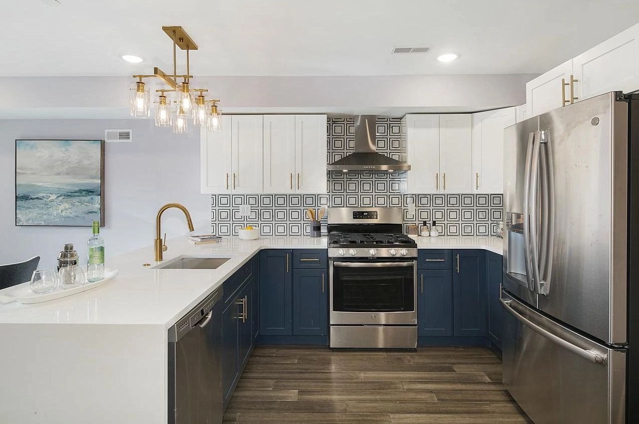 Kitchen Design Tile Design Navy Cabinet Gold Hardware Gold Faucet Ambient Lighting Quartz Appliances