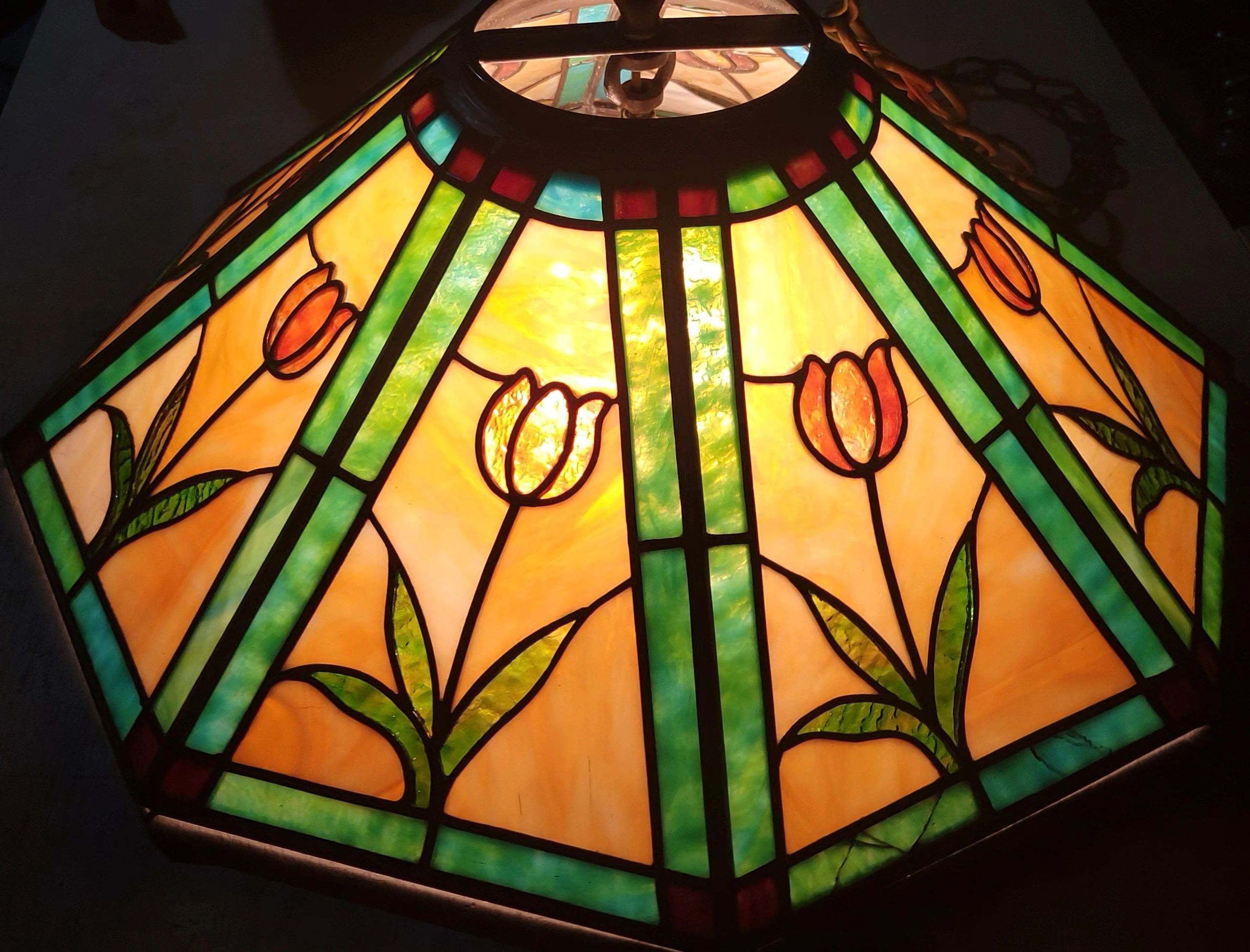 Stained glass lamp with floral design and vibrant colors.