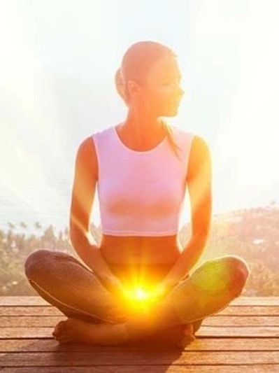 Girl sitting on a deck with the sun in her hands