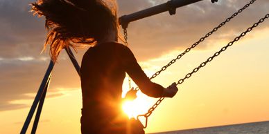 Divine Goddess
Girl on a swing with the sun setting over the ocean
