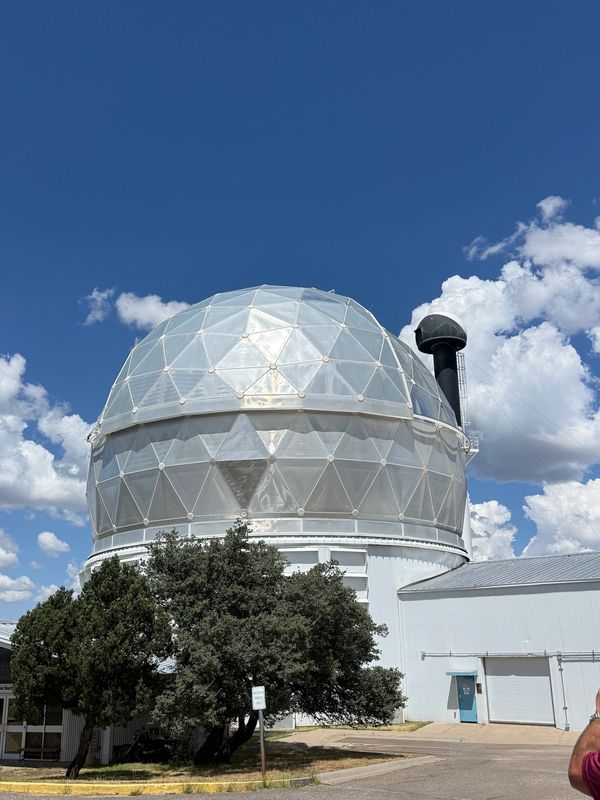 Large observatory dome under a blue sky.