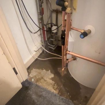 Water leak near unvented hot water cylinder highlighting importance of regular servicing
