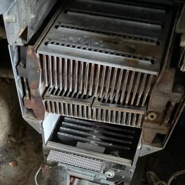 Inside of aging boiler unit used to determine cost-effective boiler repair or full replacement