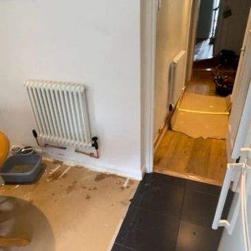 New hallway radiator installation with copper pipework and floor protection