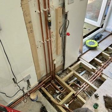 Central heating pipework laid beneath floorboards during full system installation