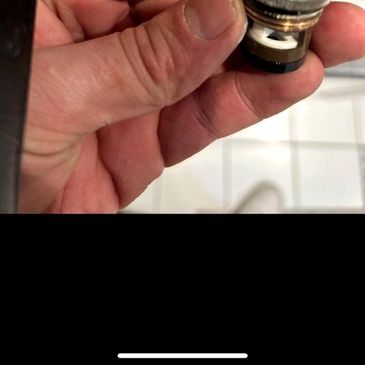 Worn and leaking tap cartridge removed during tap repair in London 