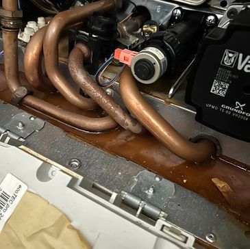 Internal leak inside Vaillant boiler – corroded copper pipes and rust staining – repair in NW6 