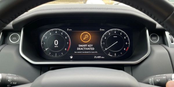 Car dashboard displaying smart key deactivated warning and mileage.