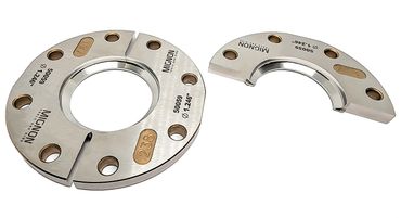 Two precision metal gauge rings with engraved markings and holes.