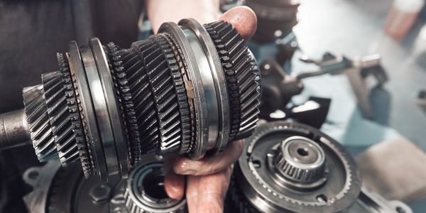 Gears being inspected during car maintenance.