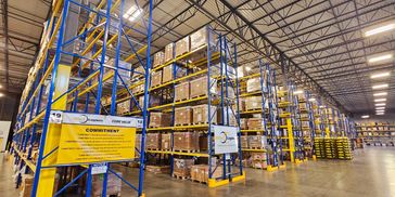 Large warehouse with organized pallet racks and boxes.