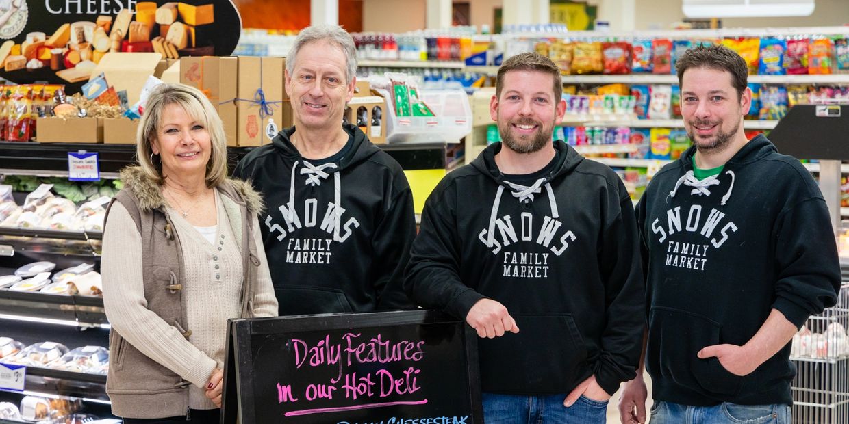 three men in black hoodie and a woman 