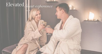 Couple in robes enjoying a luxurious spa toast.