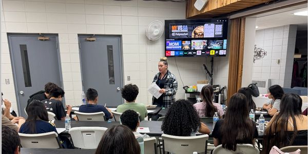 Instructor teaching students in a classroom setting.