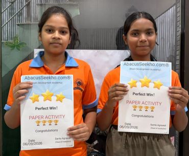 Two girls holding AbacusSeekho certificates for perfect paper activity.