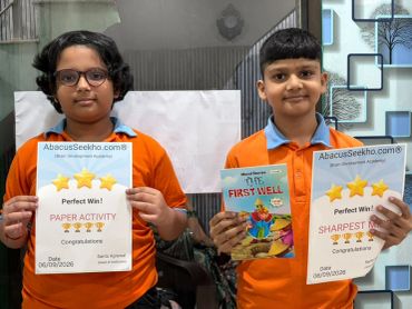 Two kids holding award certificates from AbacusSeekho.com.