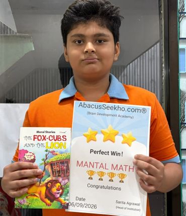 Boy holding a certificate and a storybook.