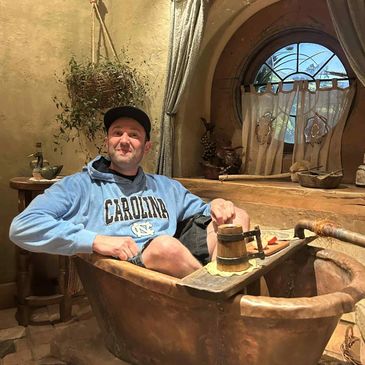 A man in a bathtub in Hobbiton, New Zealand