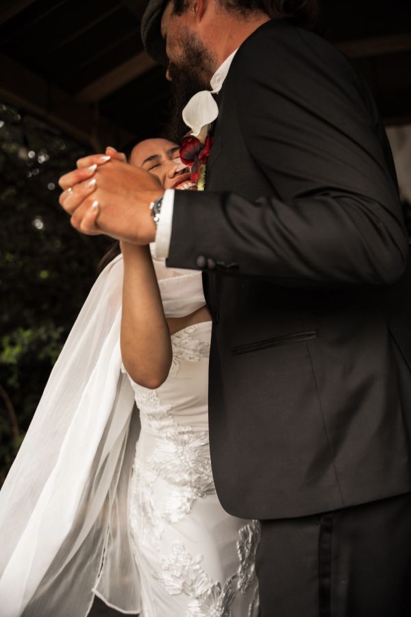 Bride and groom sharing a joyful dance at their wedding.