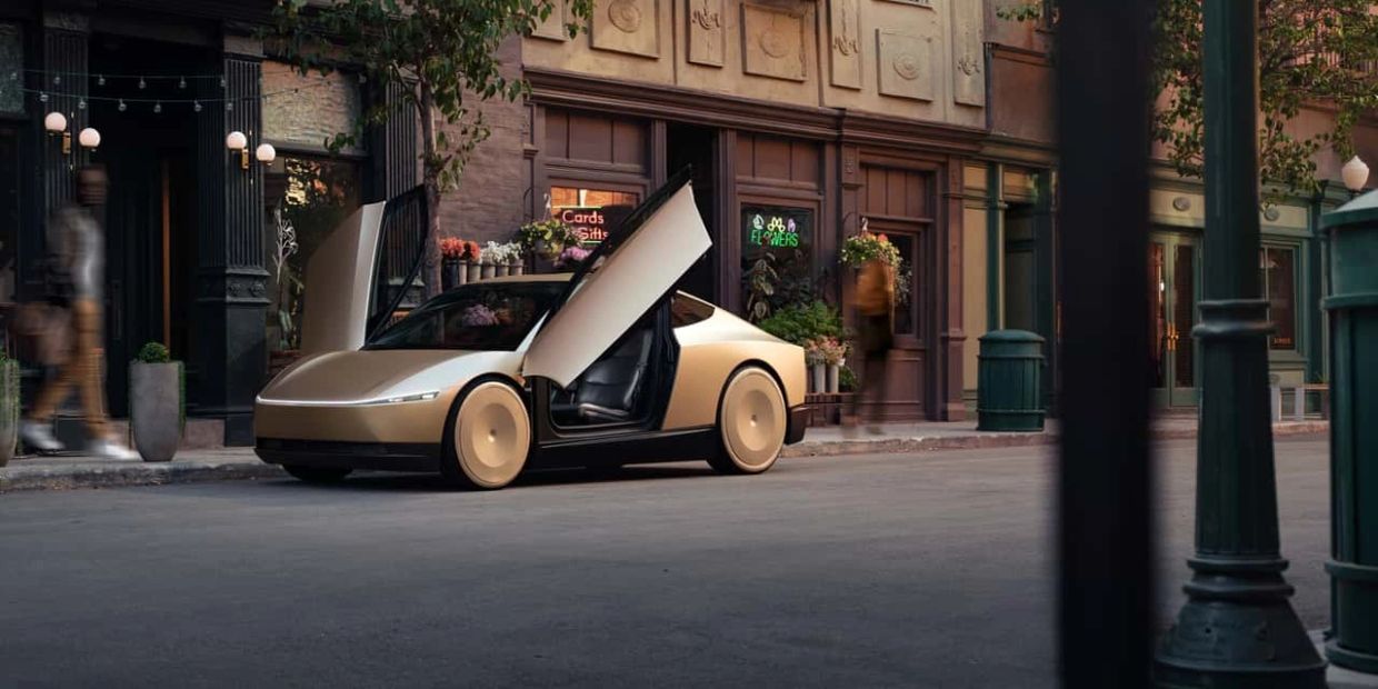 Sleek electric car with butterfly doors parked on a city street.