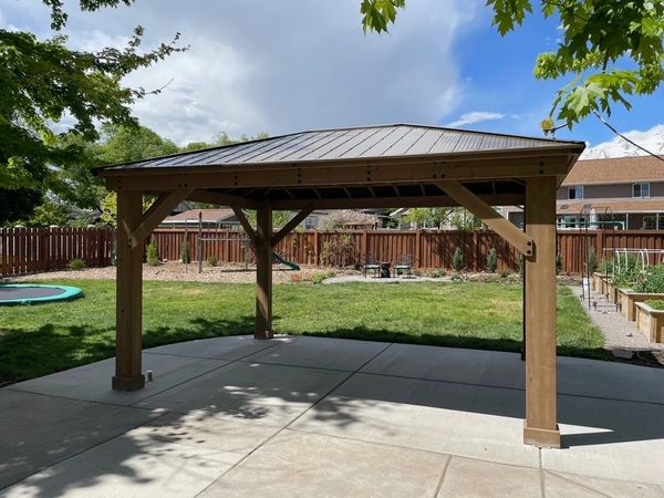 Yardistry 12x16 cedar gazebo on concrete in nice backyard in Provo, Utah