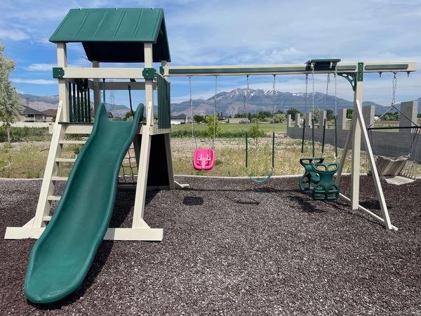 Patiova Avalanche Playset with slide and hammock chair in West Haven, Utah on mulch play area
