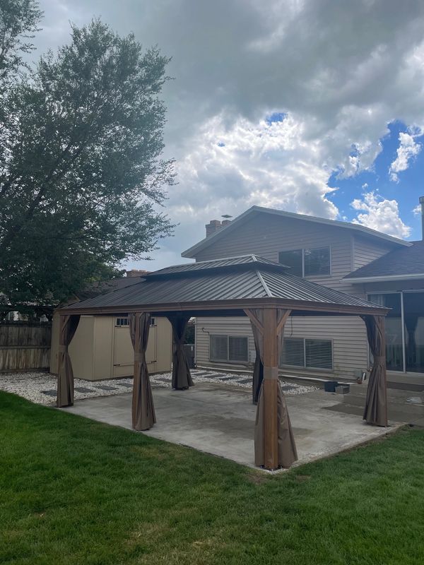 Domi 12x20 Gazebo with screens and curtain on concrete slab in Orem, Utah